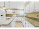 Well-equipped kitchen featuring granite countertops, white cabinets, and ample counter space at 8723 Bergeson Dr, Indianapolis, IN 46278