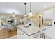Bright kitchen with an island, white cabinets, and seamless access to the living room at 8723 Bergeson Dr, Indianapolis, IN 46278
