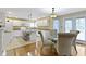 Bright eat-in kitchen featuring a center island, white cabinets, and lots of natural light at 8723 Bergeson Dr, Indianapolis, IN 46278