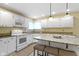Eat-in kitchen featuring white cabinets, stainless steel appliances, and a center island at 8723 Bergeson Dr, Indianapolis, IN 46278
