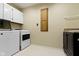Functional laundry area with modern washer and dryer units and convenient built-in cabinetry at 8723 Bergeson Dr, Indianapolis, IN 46278