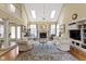 Bright and airy living room with a vaulted ceiling, a fireplace, and hardwood floors at 8723 Bergeson Dr, Indianapolis, IN 46278