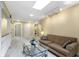 Bright and airy loft area with a skylight, comfortable sofa, and a glass coffee table at 8723 Bergeson Dr, Indianapolis, IN 46278