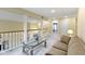 Cozy loft area with comfortable seating, glass top coffee table, and a view of the stairs at 8723 Bergeson Dr, Indianapolis, IN 46278