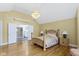 Spacious main bedroom with hardwood floors, a chandelier, and ensuite bathroom access at 8723 Bergeson Dr, Indianapolis, IN 46278