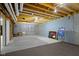 Unfinished basement space with exposed ceiling joists and concrete walls, ready for customization at 8723 Bergeson Dr, Indianapolis, IN 46278