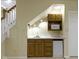 Convenient wet bar area with sink, cabinets, mini-refrigerator, and countertop space at 8723 Bergeson Dr, Indianapolis, IN 46278