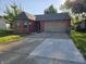 Charming single-story brick home with attached two-car garage and a concrete driveway at 8810 Summer Walk E Dr, Indianapolis, IN 46227