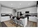 Modern kitchen features sleek countertops, stainless steel appliances, a central island with bar seating, and hardwood floors at 8838 Alexander Ridge Dr, McCordsville, IN 46055