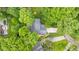 An aerial view features a home with driveway, lawn, and surrounding greenery showing a lush, established landscape at 8934 Pinyon Ct, Indianapolis, IN 46260
