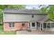 Back of home with patio, screened porch, brick accents and lush backyard at 8934 Pinyon Ct, Indianapolis, IN 46260
