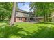 Expansive backyard featuring a large patio area, screened-in porch and lush green lawn at 8934 Pinyon Ct, Indianapolis, IN 46260