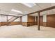 Finished basement with stairs, paneled walls, and carpeted flooring at 8934 Pinyon Ct, Indianapolis, IN 46260