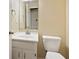 Bathroom featuring a single sink vanity with a toilet and mirror at 8934 Pinyon Ct, Indianapolis, IN 46260