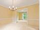 Dining room featuring plush carpet, neutral paint, a decorative chandelier and view into living room at 8934 Pinyon Ct, Indianapolis, IN 46260