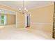 Dining room featuring plush carpet, neutral paint, a decorative chandelier and view into kitchen at 8934 Pinyon Ct, Indianapolis, IN 46260