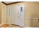 Bright foyer with a white front door flanked by sidelights and hardwood floors at 8934 Pinyon Ct, Indianapolis, IN 46260