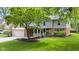 Inviting front exterior with well-maintained lawn, brick accents, covered porch, and attached garage at 8934 Pinyon Ct, Indianapolis, IN 46260
