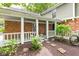 Charming covered porch with brick columns, stepping stones, and garden bed at 8934 Pinyon Ct, Indianapolis, IN 46260