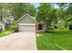 Charming two-story home featuring an attached garage and a well-manicured lawn at 8934 Pinyon Ct, Indianapolis, IN 46260