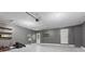 Spacious garage with gray painted walls, door to outside, and storage shelving at 8934 Pinyon Ct, Indianapolis, IN 46260