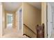 Hallway featuring carpet, wood railing, and a doorway into a bedroom at 8934 Pinyon Ct, Indianapolis, IN 46260