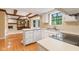 Bright kitchen with hardwood floors, white cabinets, stainless steel sink and view to the living room at 8934 Pinyon Ct, Indianapolis, IN 46260