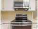 This kitchen features stainless steel appliances, including a microwave and glass top stove at 8934 Pinyon Ct, Indianapolis, IN 46260