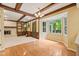 Spacious living room with hardwood floors, a fireplace, built-in shelving, and coffered ceiling at 8934 Pinyon Ct, Indianapolis, IN 46260