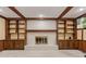 Cozy living room with brick fireplace, built-in shelves, and wood trim at 8934 Pinyon Ct, Indianapolis, IN 46260