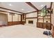 Living room features a white brick fireplace, wood paneling, recessed lights, and built-in shelving at 8934 Pinyon Ct, Indianapolis, IN 46260