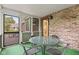 Relaxing screened porch with table, chairs, and serene wooded views at 8934 Pinyon Ct, Indianapolis, IN 46260