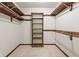 A carpeted walk-in closet with wood shelving and hanging rods at 8934 Pinyon Ct, Indianapolis, IN 46260