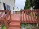 A well-maintained wood back deck with a view of the rest of the yard and neighborhood at 8939 Newchurch Blvd, Indianapolis, IN 46231