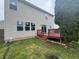 View of the wood deck in the backyard with grass and trees at 8939 Newchurch Blvd, Indianapolis, IN 46231