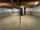 Spacious unfinished basement with white walls and support beams, offering potential for customization at 8939 Newchurch Blvd, Indianapolis, IN 46231