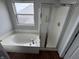 Bathroom with a tub with shower and a window at 8939 Newchurch Blvd, Indianapolis, IN 46231