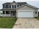 Charming two-story home with a covered porch, black shutters, and an attached two-car garage at 8939 Newchurch Blvd, Indianapolis, IN 46231