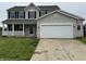 Charming two-story home with a covered porch, black shutters, and an attached two-car garage at 8939 Newchurch Blvd, Indianapolis, IN 46231