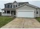 Charming two-story home with a white garage door, and a cozy front porch at 8939 Newchurch Blvd, Indianapolis, IN 46231