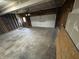 Two-car garage with a white door and an automatic opener, offering ample parking and storage space at 8939 Newchurch Blvd, Indianapolis, IN 46231