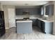Modern kitchen with grey cabinets, stainless steel appliances, white countertops, and a large island at 8939 Newchurch Blvd, Indianapolis, IN 46231