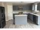 Kitchen featuring gray cabinets, stainless steel appliances, and an island with marble countertops at 8939 Newchurch Blvd, Indianapolis, IN 46231