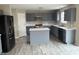 An open kitchen features gray cabinets, white countertops, stainless appliances, and an island at 8939 Newchurch Blvd, Indianapolis, IN 46231