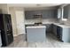 Modern kitchen with grey cabinets, stainless steel appliances, white countertops, and a large island at 8939 Newchurch Blvd, Indianapolis, IN 46231