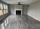 Beautiful living room with sleek floors, a ceiling fan and a fireplace, perfect for entertaining guests at 8939 Newchurch Blvd, Indianapolis, IN 46231