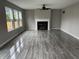 Open living room featuring sleek floors, a ceiling fan and a cozy fireplace for relaxation at 8939 Newchurch Blvd, Indianapolis, IN 46231