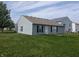 Backyard featuring grassy lawn and partial view of the home's exterior at 901 Westpointe Dr, Shelbyville, IN 46176