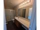 Clean bathroom with vanity sink, lighting, and shower at 901 Westpointe Dr, Shelbyville, IN 46176