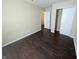 Bedroom featuring hardwood floors, closet, and doorway to hallway at 901 Westpointe Dr, Shelbyville, IN 46176